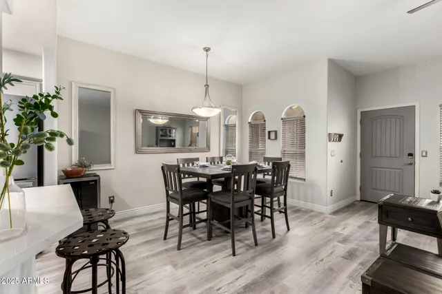 a view of a a dining room with furniture window and wooden floor