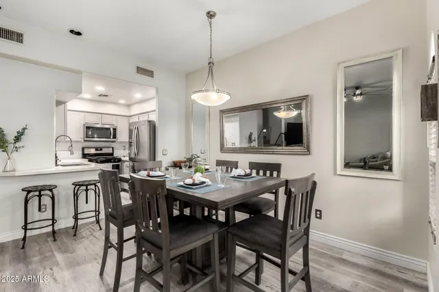 a view of a a dining room with furniture window and wooden floor