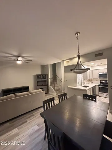 a living room with furniture and a chandelier