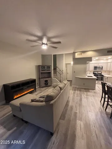 a living room with furniture and kitchen view