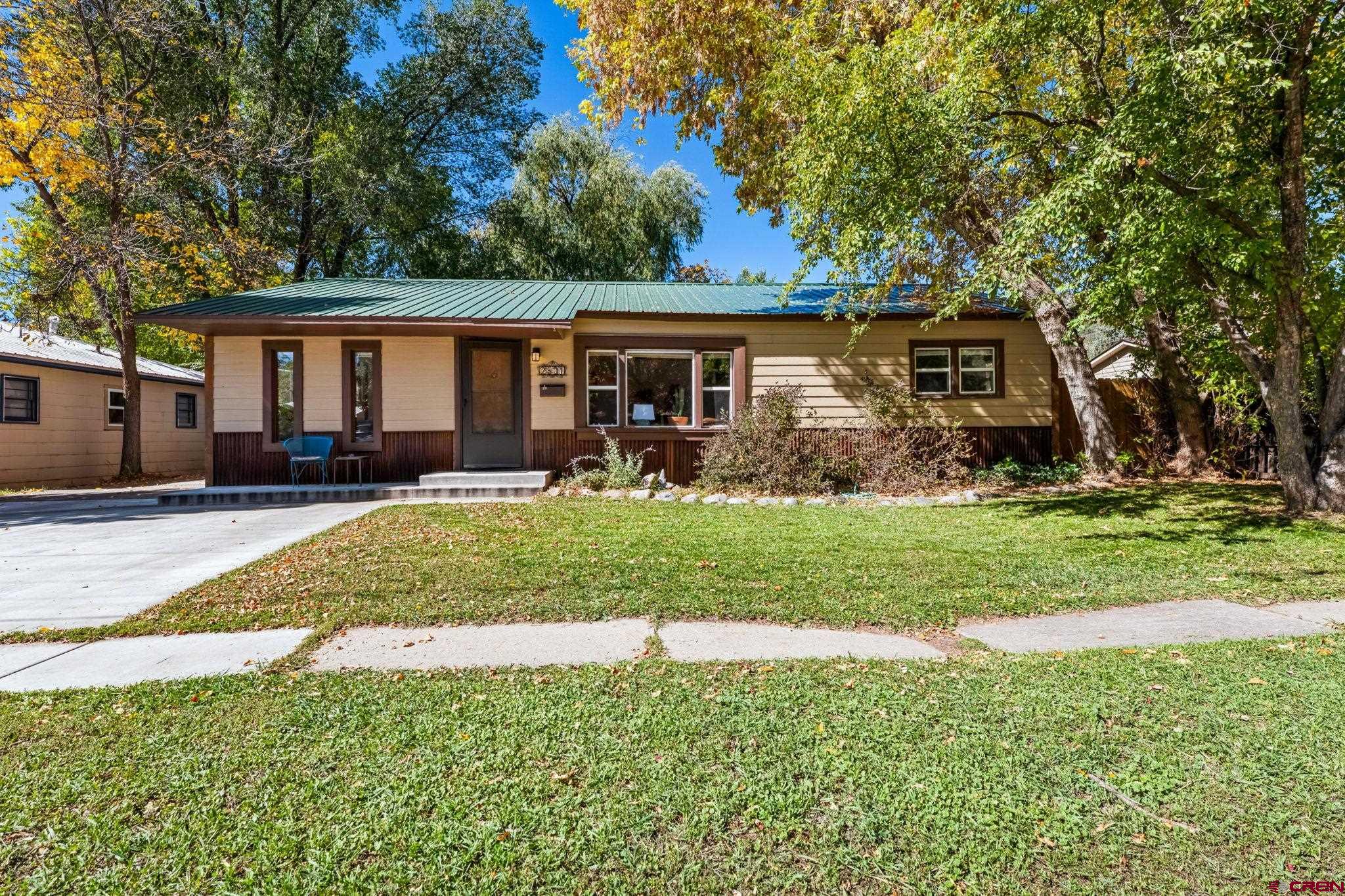 a front view of house with yard and green space
