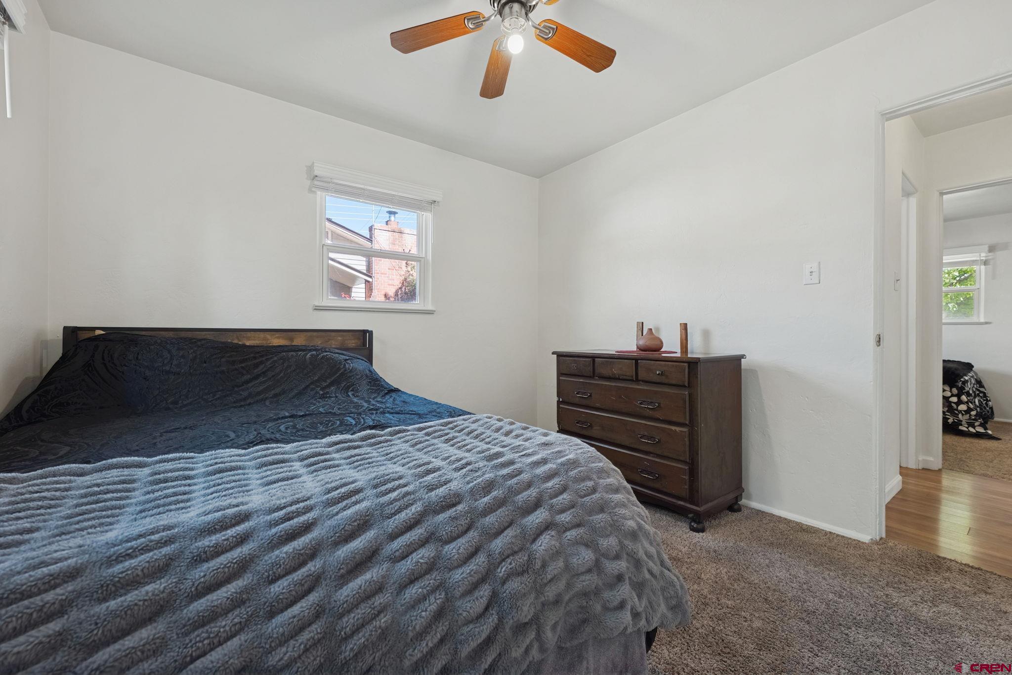 2807 Junction Street Durango, CO 81301 - Photo 13 of 26 a bedroom with a bed and a chandelier