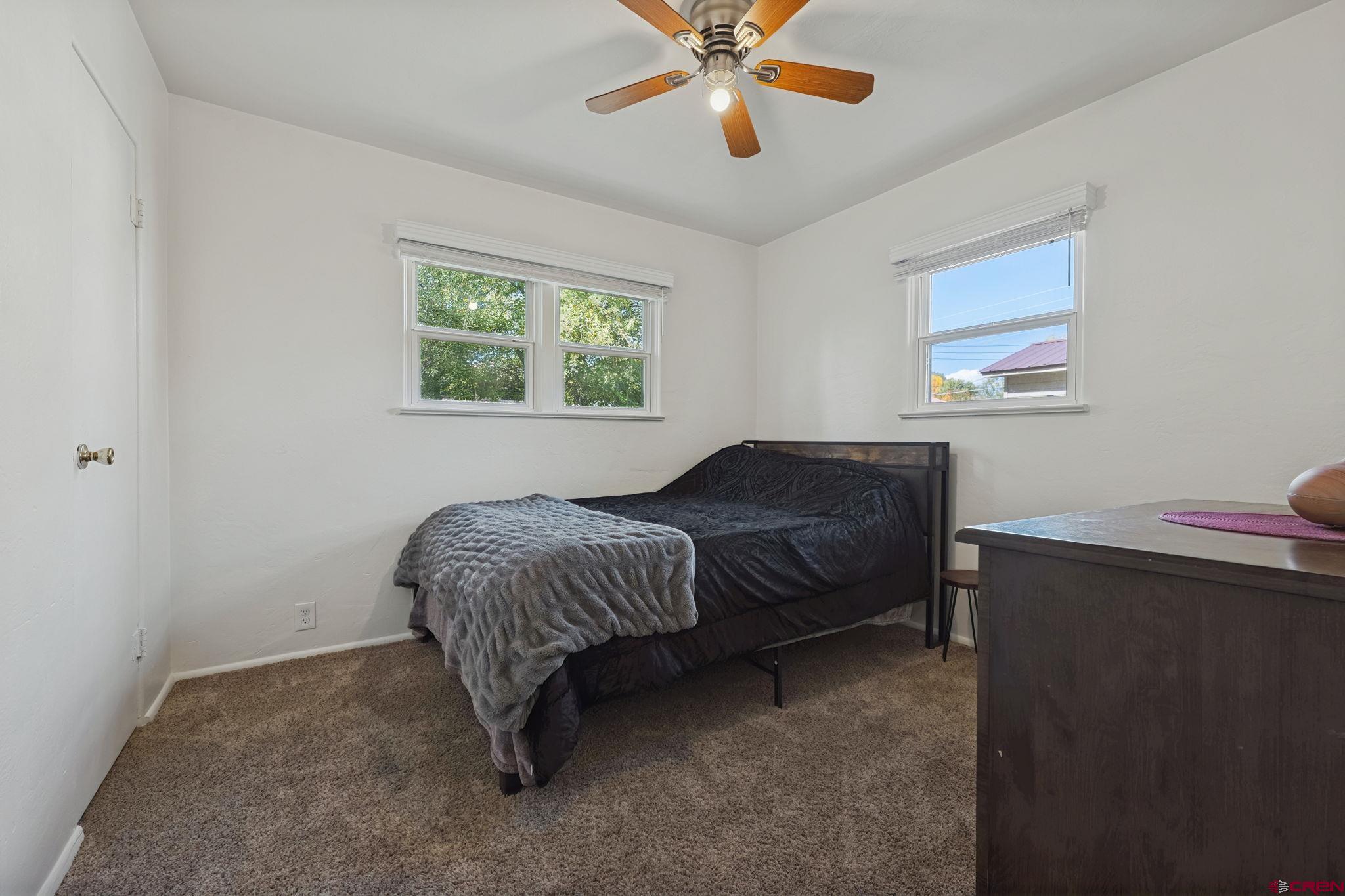 2807 Junction Street Durango, CO 81301 - Photo 15 of 26 a bedroom with a bed and a chandelier