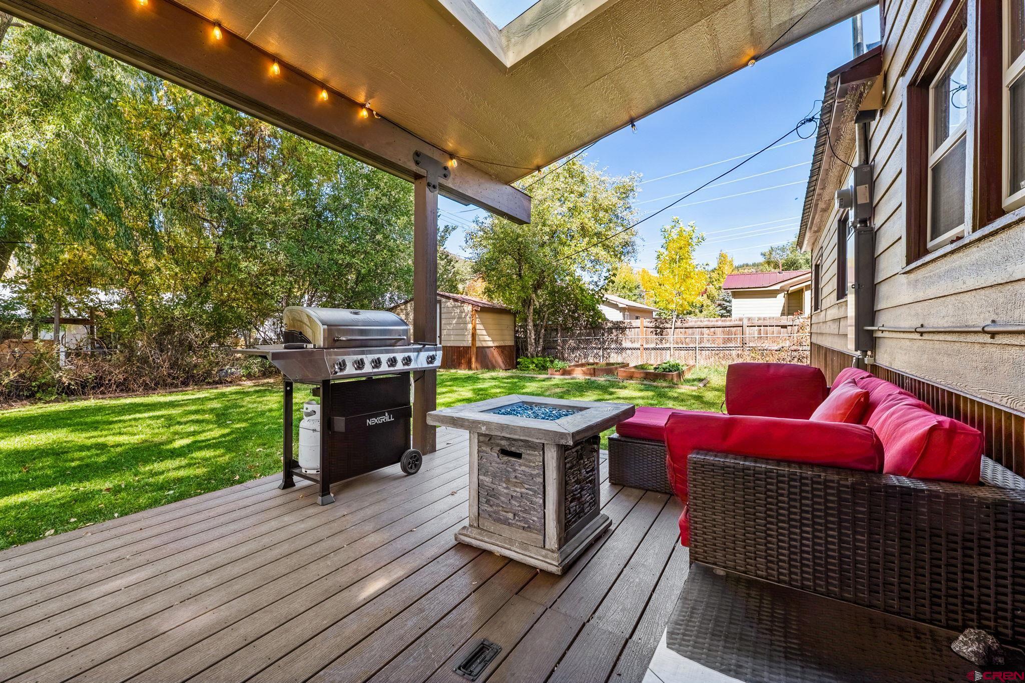 2807 Junction Street Durango, CO 81301 - Photo 20 of 26 a view of a patio with table and chairs potted plants with wooden floor and fence
