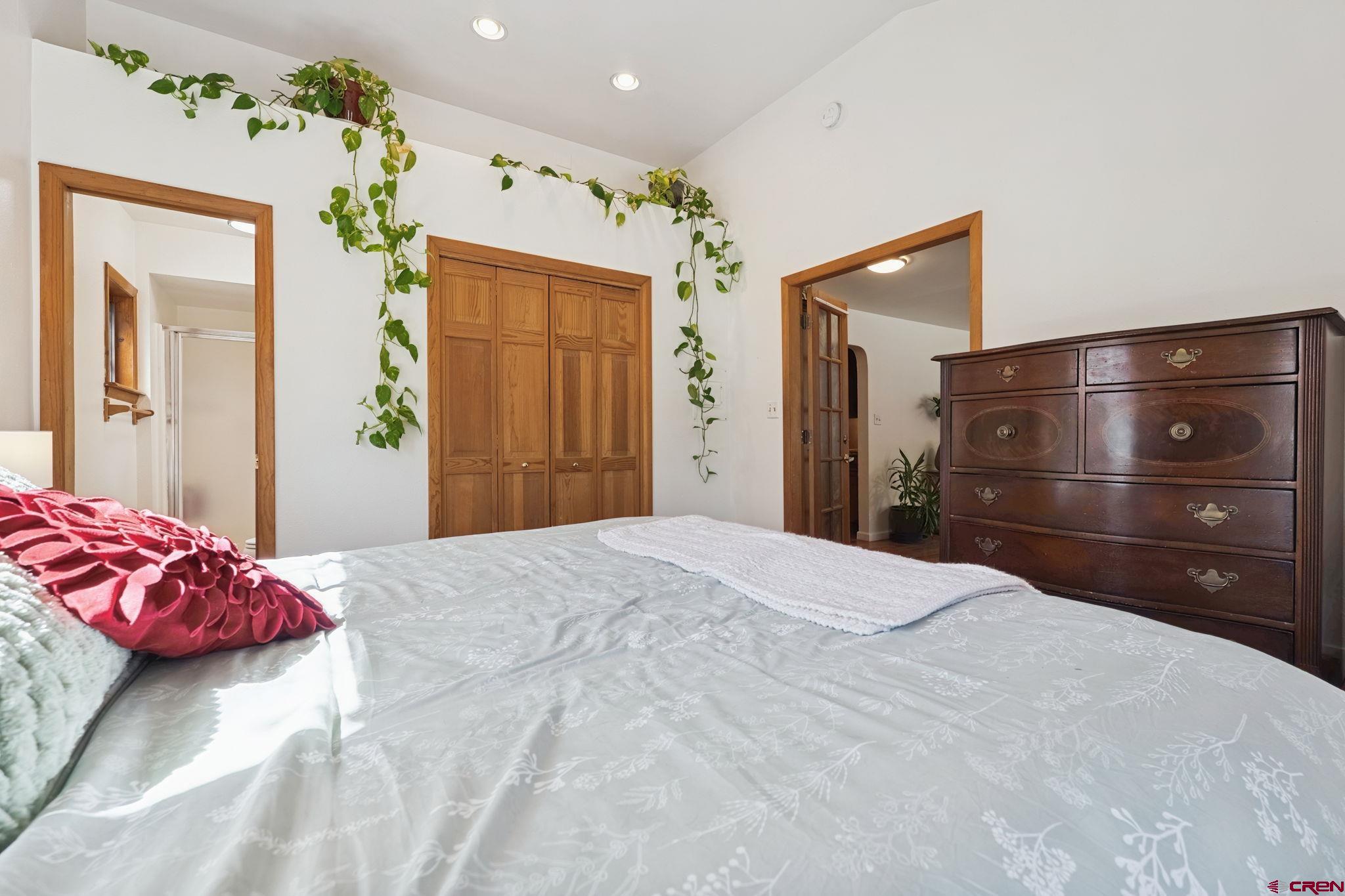 2807 Junction Street Durango, CO 81301 - Photo 10 of 26 a bedroom with a bed a dresser and a chandelier