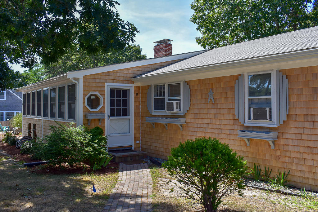 101 Lower County Road, Unit 7B Dennis Port, MA 02639 - Photo 1 of 17 a view of a house with a yard