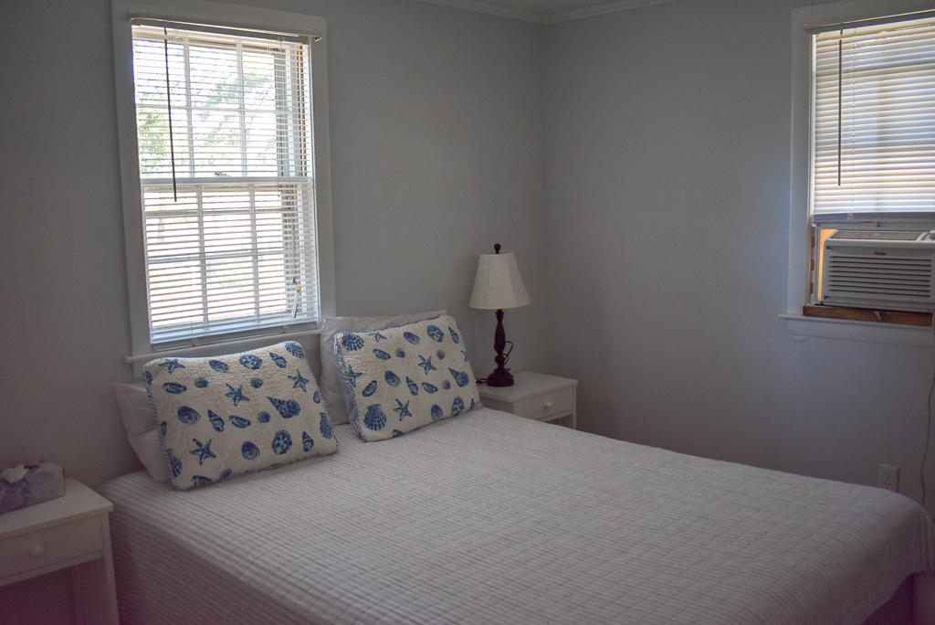 101 Lower County Road, Unit 7B Dennis Port, MA 02639 - Photo 12 of 17 a bed sitting in a bedroom next to a window
