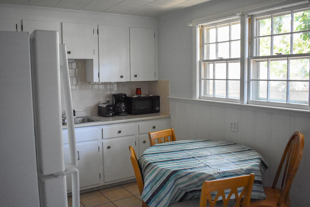 101 Lower County Road, Unit 7B Dennis Port, MA 02639 - Photo 17 of 17 a bedroom with bed cabinets and window