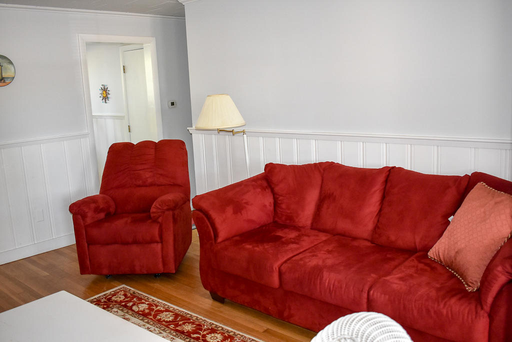 101 Lower County Road, Unit 7B Dennis Port, MA 02639 - Photo 4 of 17 a living room with furniture and a lamp