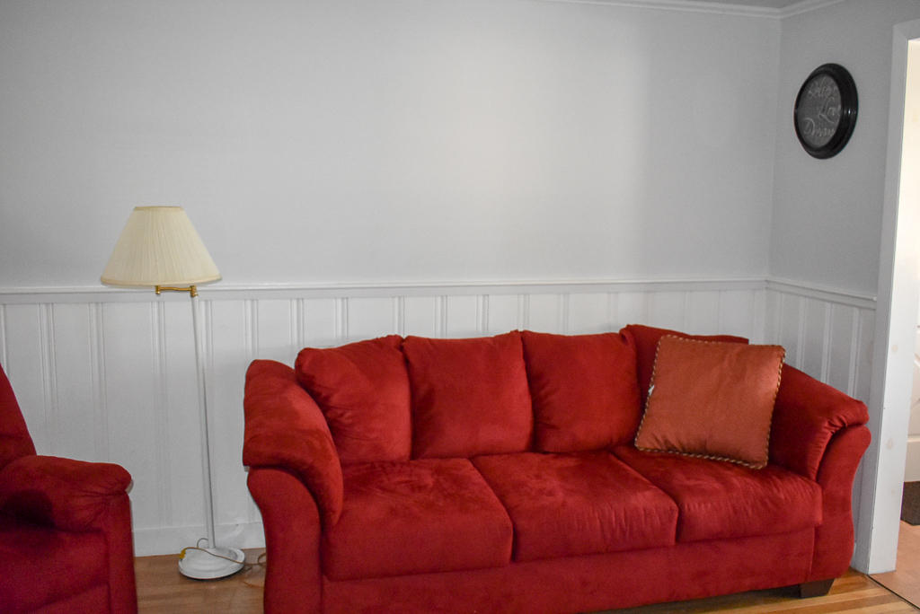 101 Lower County Road, Unit 7B Dennis Port, MA 02639 - Photo 5 of 17 a blue couch sitting in a living room with a rug