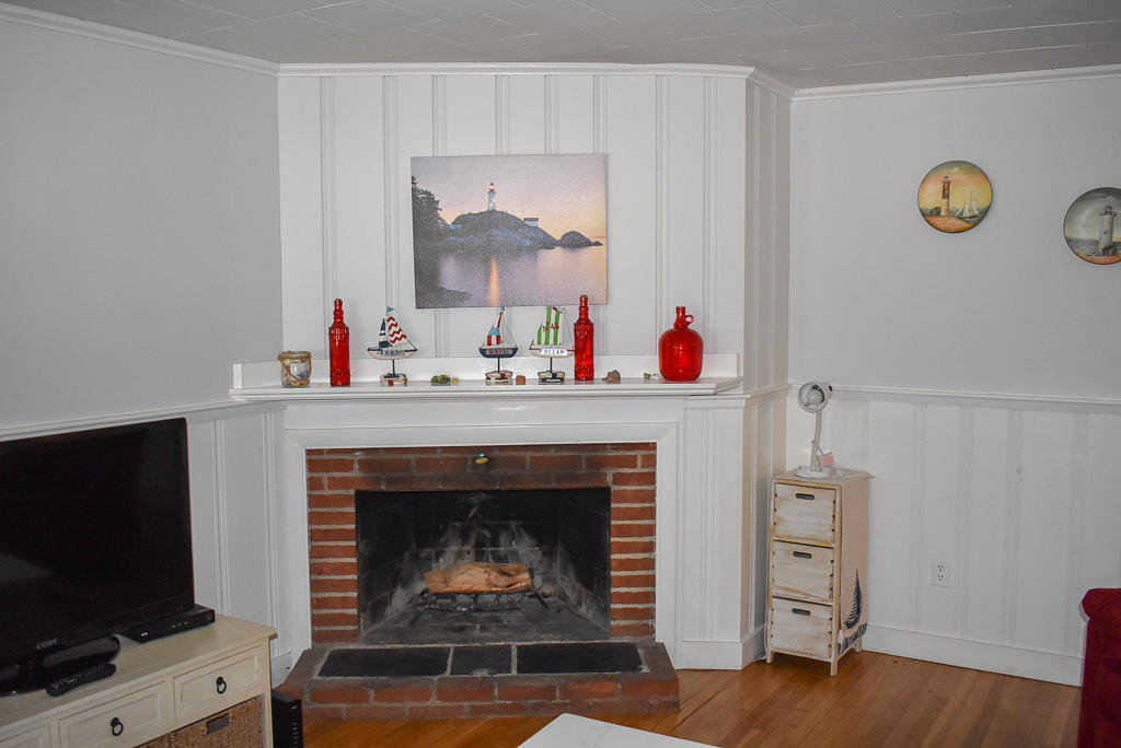 101 Lower County Road, Unit 7B Dennis Port, MA 02639 - Photo 8 of 17 a living room with furniture and a fireplace