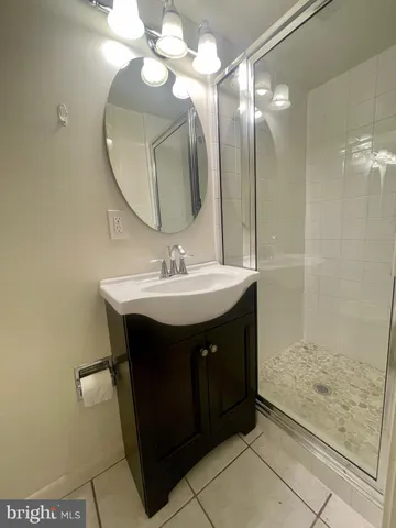 a bathroom with a sink vanity and a mirror