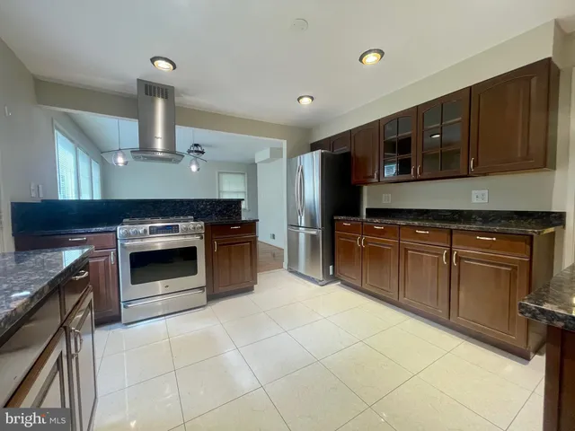 a kitchen with stainless steel appliances granite countertop a stove and a sink