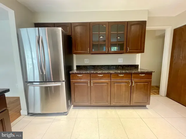 a kitchen with stainless steel appliances granite countertop a refrigerator and a stove