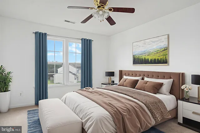 a bedroom with a bed and a painting on the wall