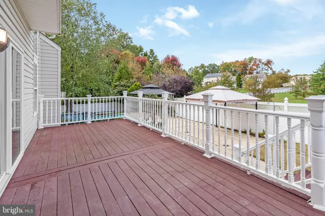 a view of balcony with wooden floor and fence