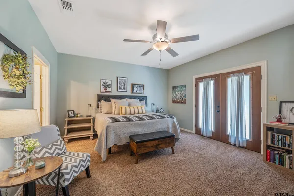 a bed sitting in a bedroom next to a window