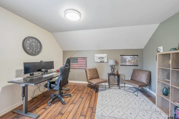 a work room with furniture and a clock
