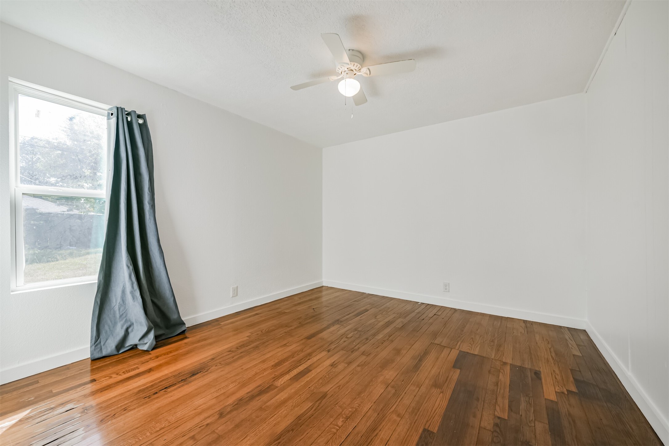 7546 Greendowns Street Houston, TX 77087 - Photo 25 of 33 wooden floor in an empty room with a window