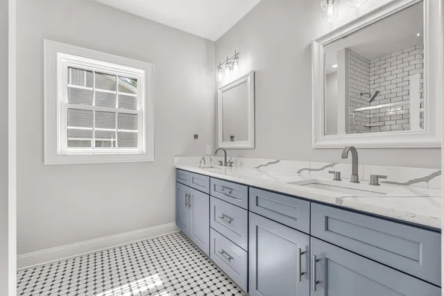a bathroom with a sink double vanity and a shower