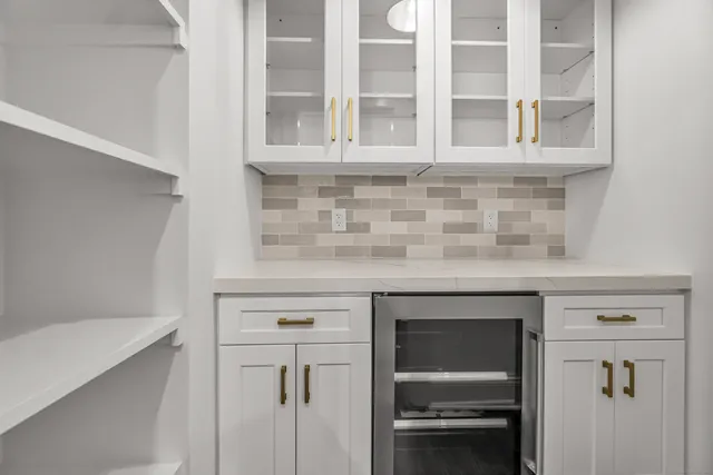 a kitchen with white cabinets and a white stove