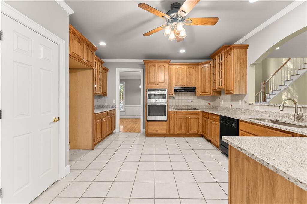 1040 Auburn Road Dacula, GA 30019 - Photo 15 of 42 a large kitchen with a stove a sink dishwasher and a refrigerator