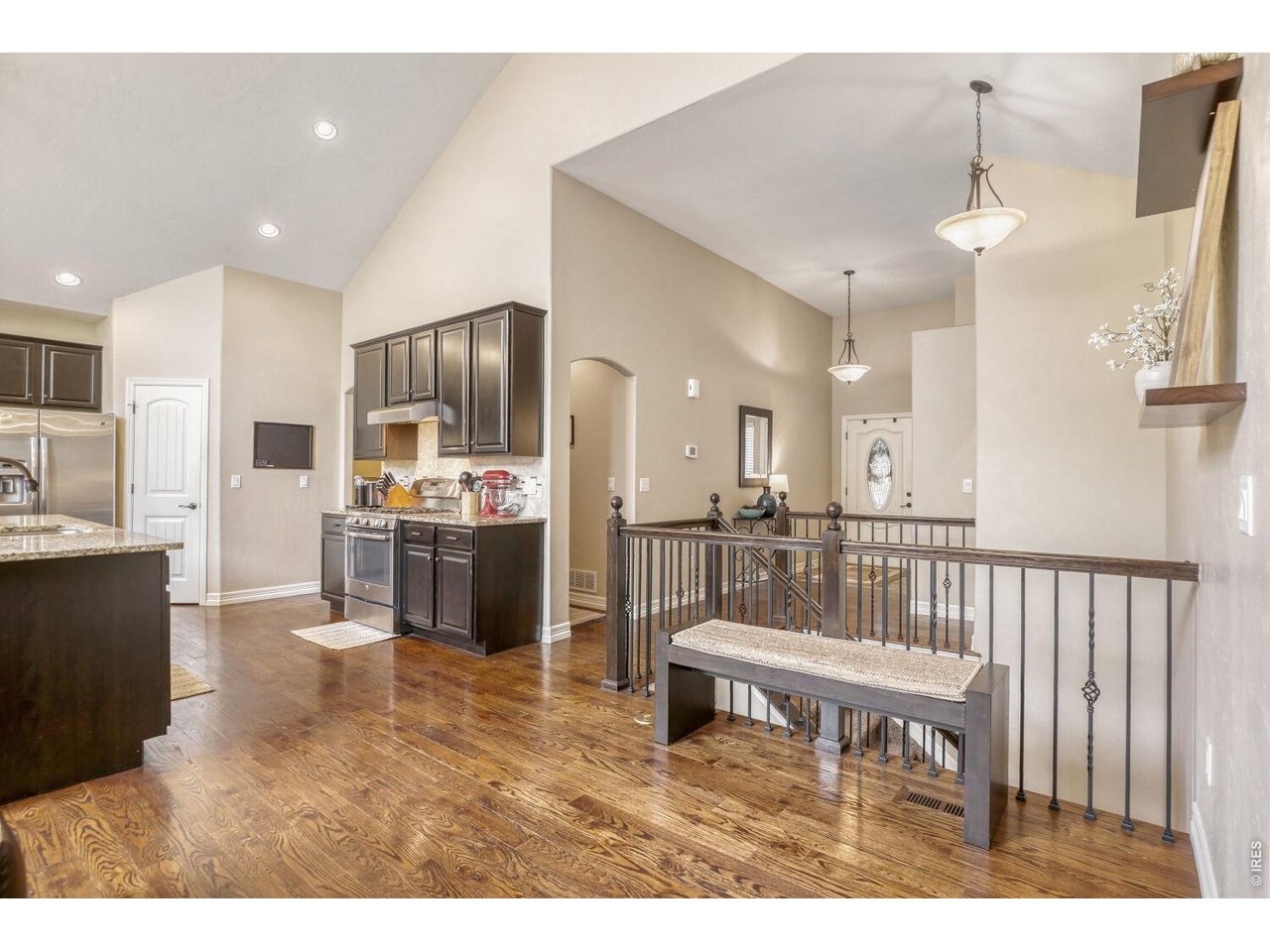 7992 St Street Frederick, CO 80530 - Photo 2 of 28 a living room with kitchen island furniture and a kitchen view