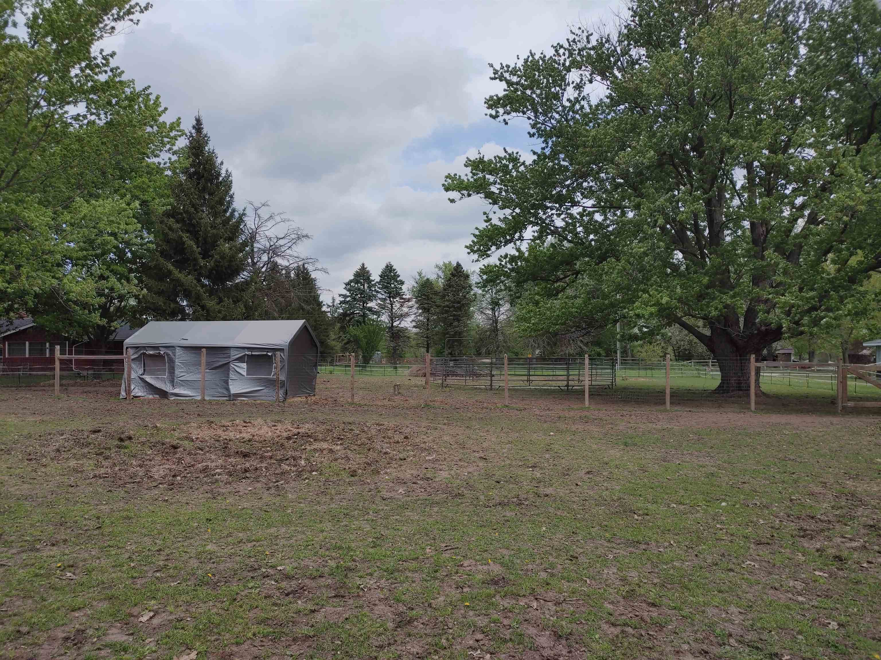5515 Rotary Road Cherry Valley, IL 61016 - Photo 13 of 31 a backyard of a house with lots of green space