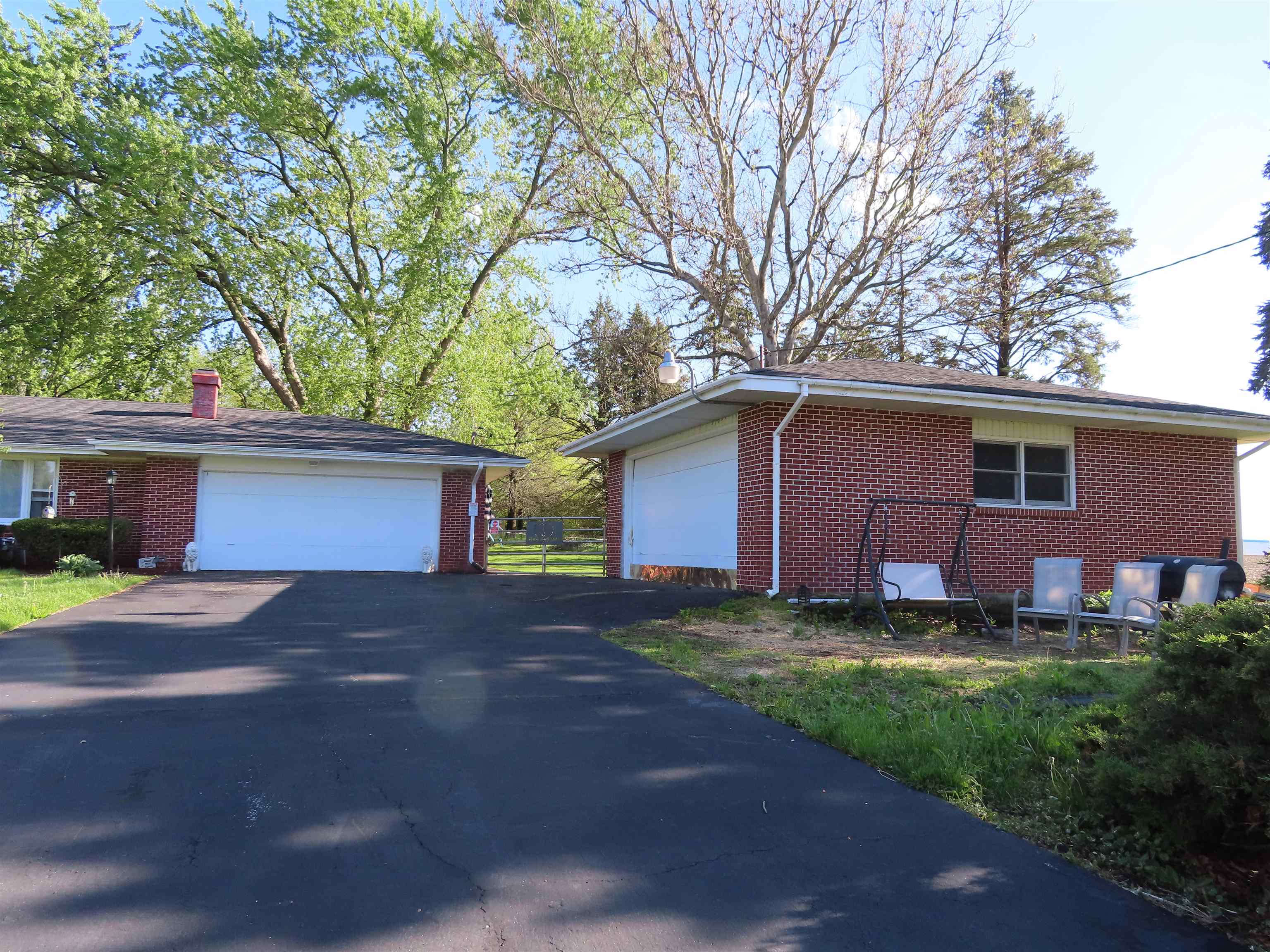 5515 Rotary Road Cherry Valley, IL 61016 - Photo 2 of 31 a front view of a house with a yard and garage