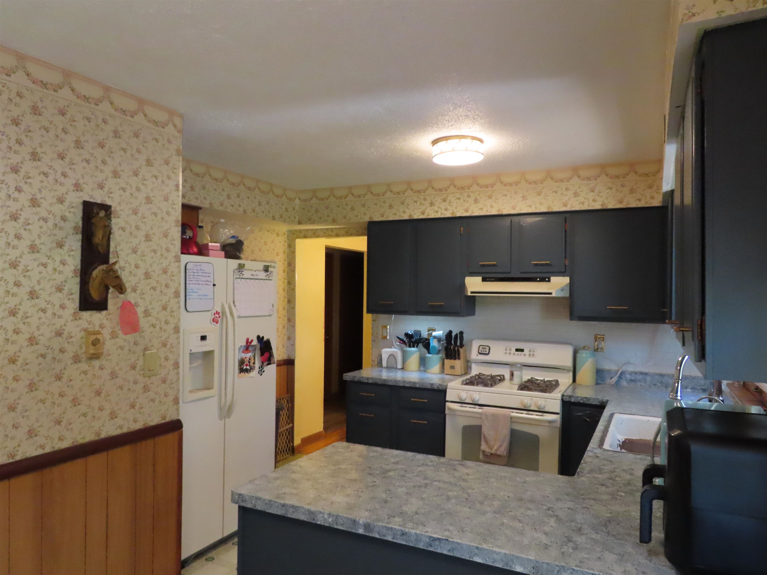 5515 Rotary Road Cherry Valley, IL 61016 - Photo 23 of 31 a kitchen with a sink a stove and refrigerator