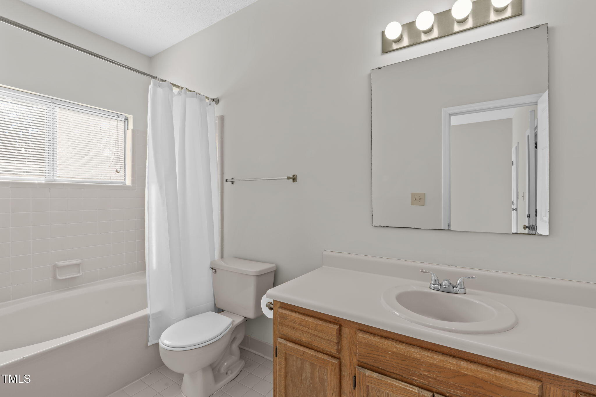 6131 Summer Pointe Place, Unit 101 Raleigh, NC 27606 - Photo 13 of 21 a bathroom with a sink a toilet and shower