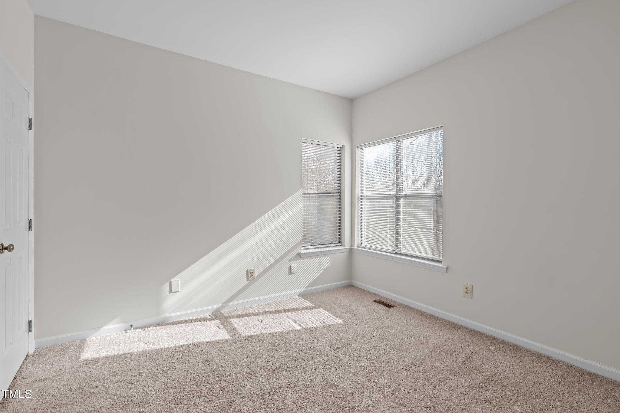 6131 Summer Pointe Place, Unit 101 Raleigh, NC 27606 - Photo 14 of 21 an empty room with windows