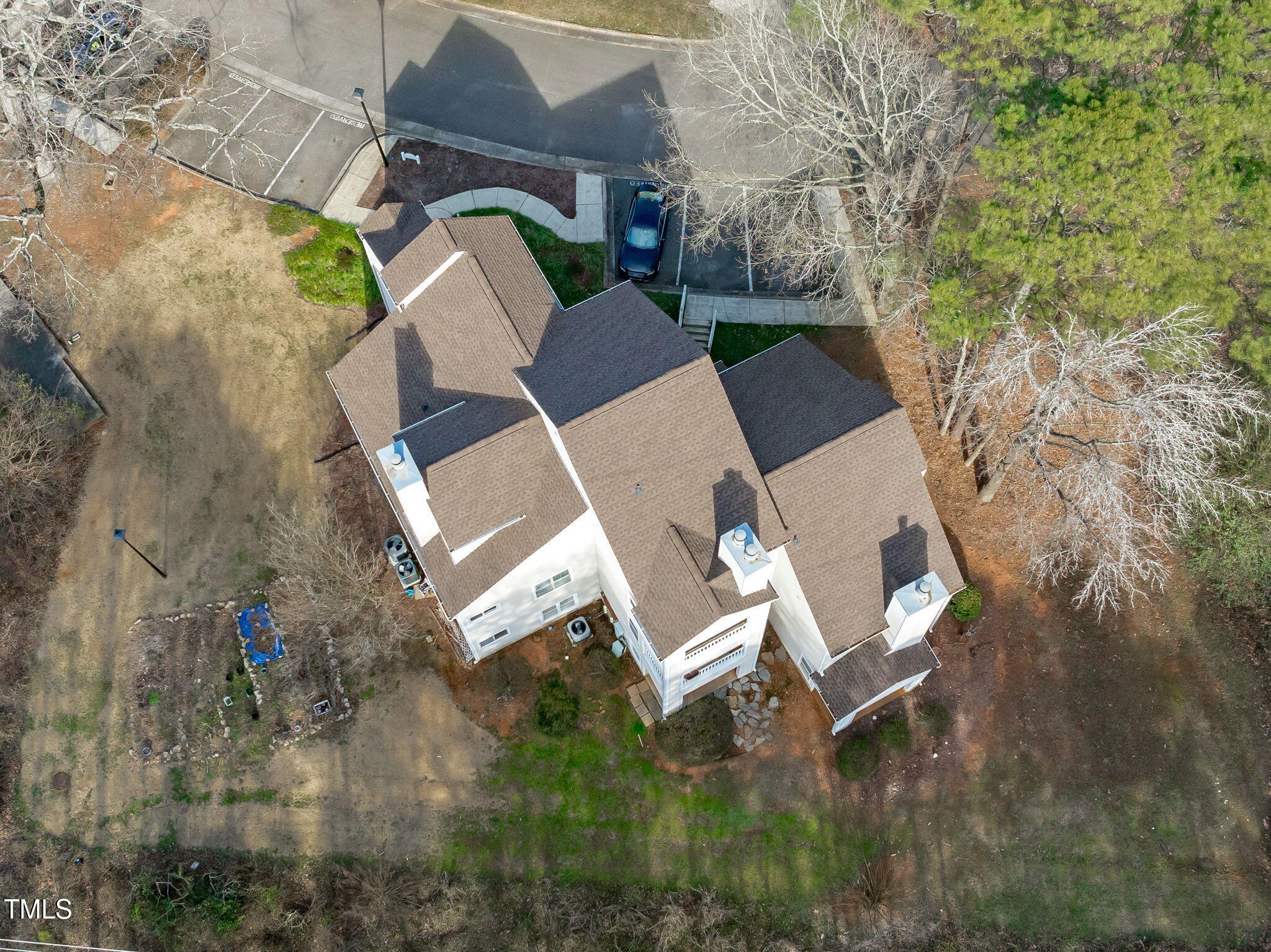 6131 Summer Pointe Place, Unit 101 Raleigh, NC 27606 - Photo 19 of 21 an aerial view of a house with outdoor space and a garden