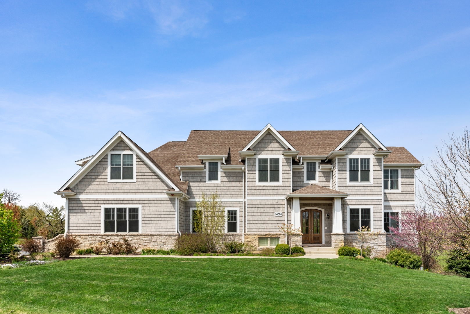 a front view of house with yard and green space
