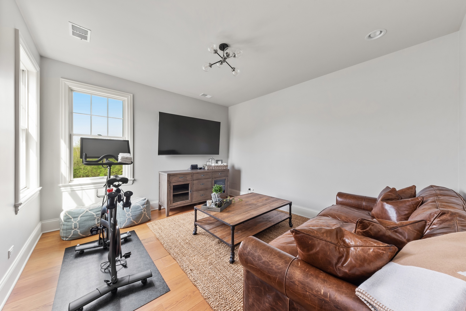 26070 West Sunset Road Barrington, IL 60010 - Photo 20 of 30 a living room with furniture a flat screen tv and a floor to ceiling window