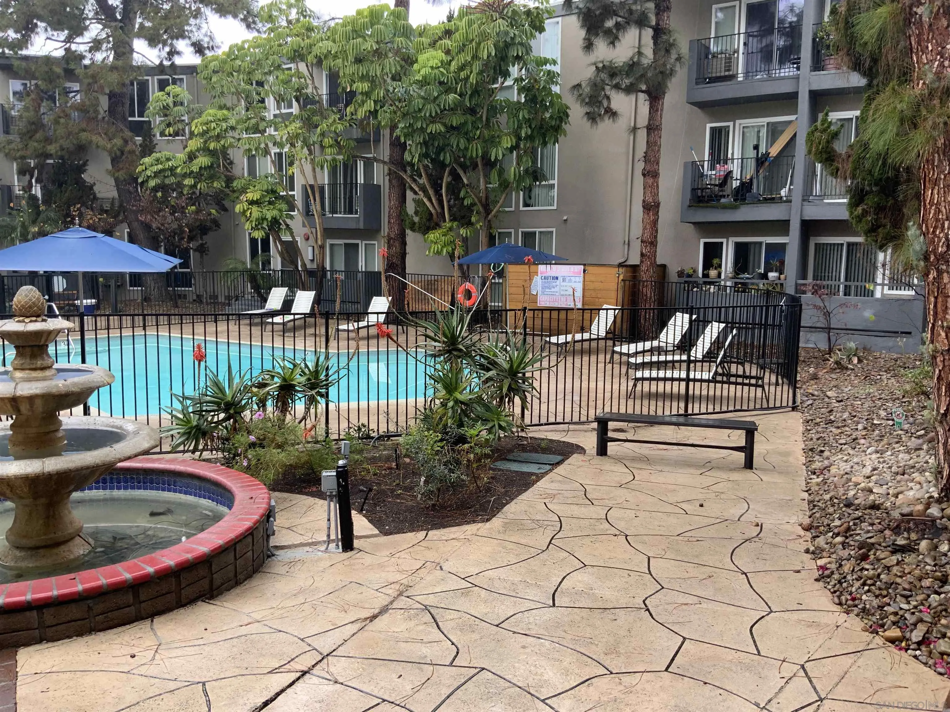 a backyard of a house with barbeque oven table and chairs