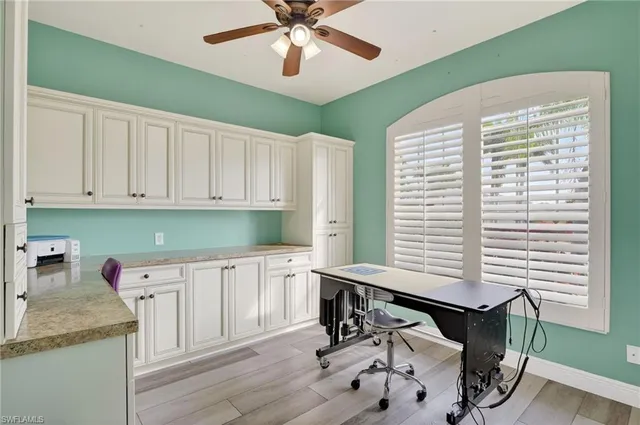 a kitchen with a table chairs and white cabinets