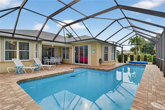 a view of house with swimming pool patio and outdoor seating