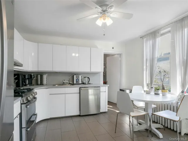 a kitchen with cabinets stainless steel appliances and a sink