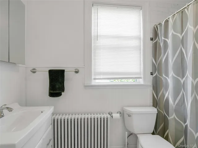 a bedroom with a bed and a mirror