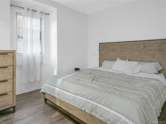 a bedroom with a bed and window