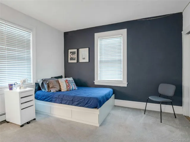 a bedroom with a bed couch and window