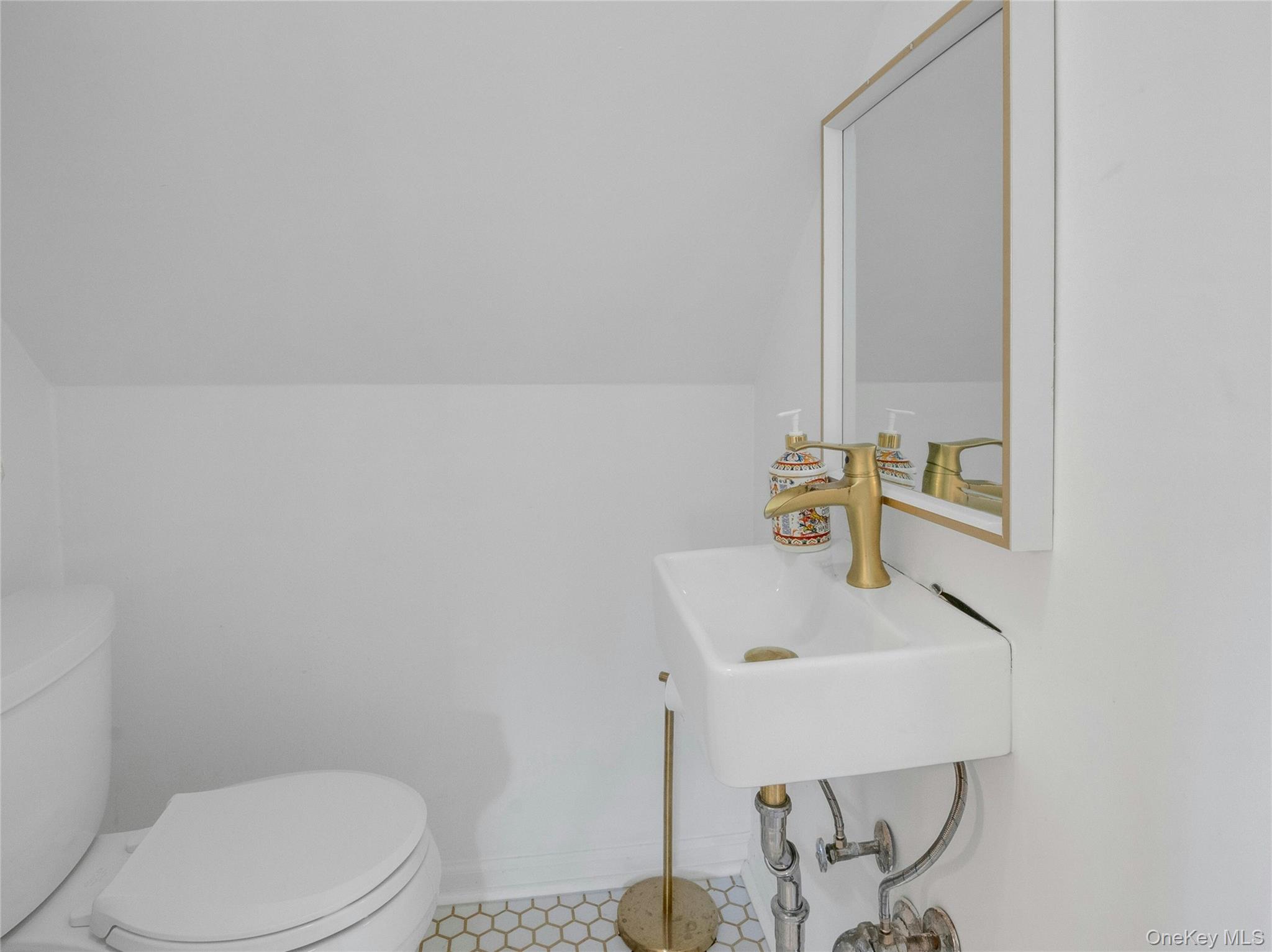 46 Meadow Lane New Rochelle, NY 10805 - Photo 27 of 42 a bathroom with a sink a toilet and mirror