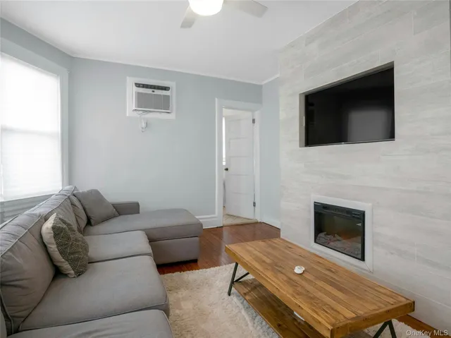 a living room with a rug and a fireplace