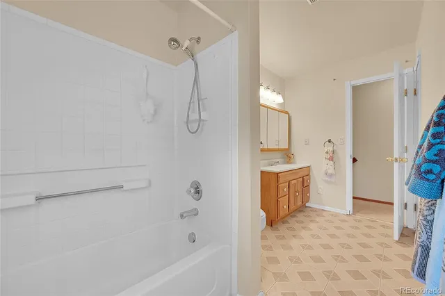 a bathroom with a tub sink and mirror