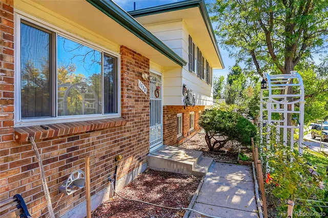 a view of a brick house with a yard
