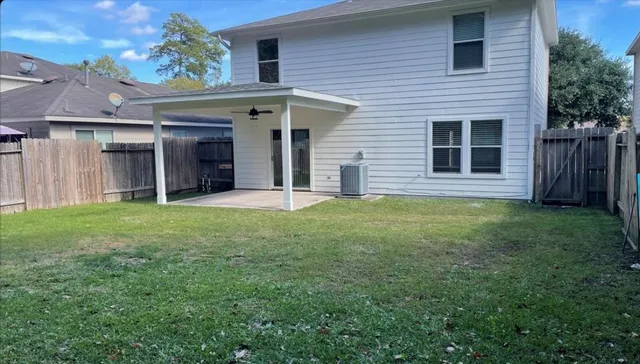 a view of a house with backyard and porch