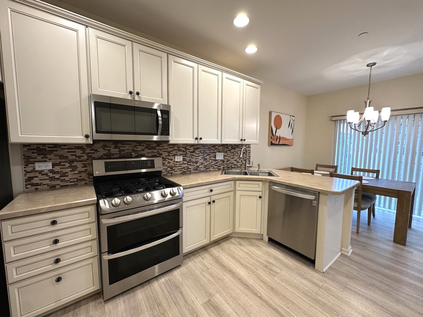 5102 Monroe Street Matteson, IL 60443 - Photo 12 of 54 a kitchen with granite countertop a stove a sink and a microwave