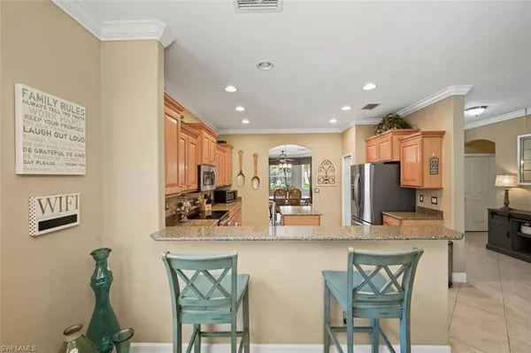 a kitchen with stainless steel appliances granite countertop a refrigerator and a sink