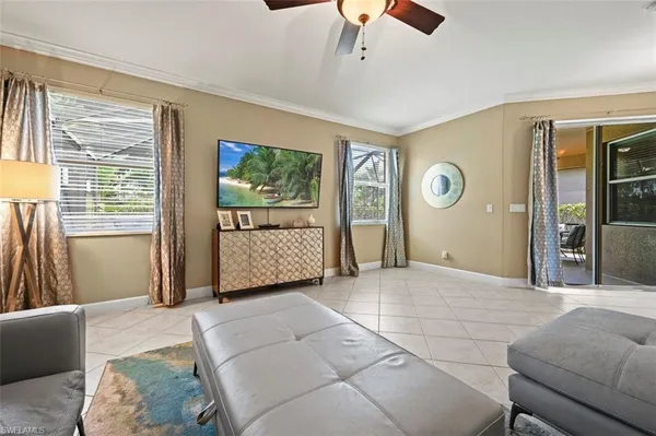 a bedroom with a large bed a chandelier and dresser